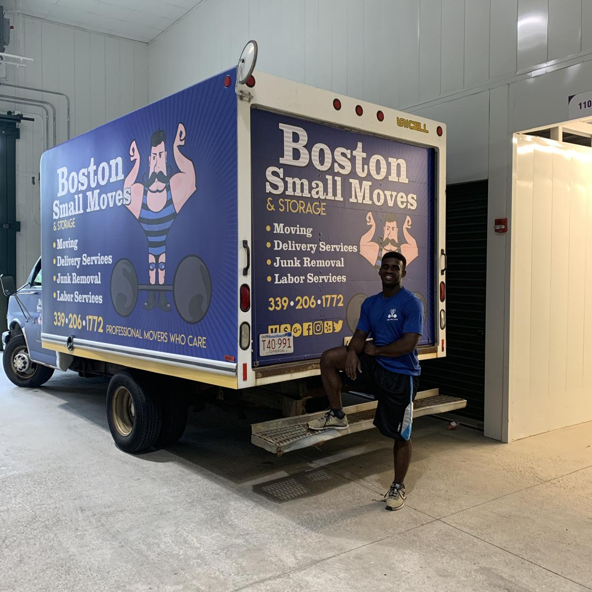 A Boston Small Moves crew member beside the company truck